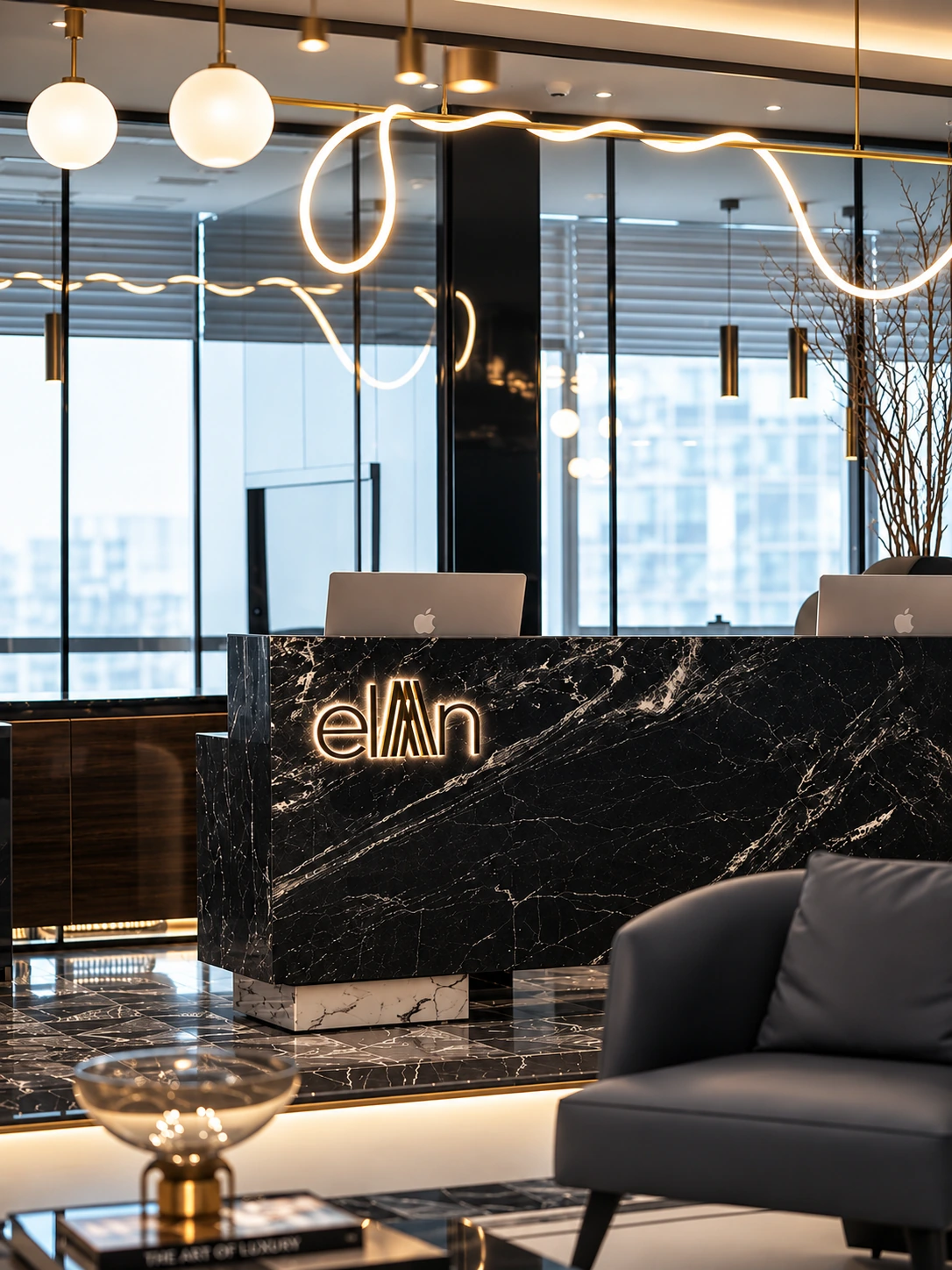 Reception of an Elan Group property, with the Elan wordmark on a black marble desk